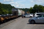 People going to and from the festival in downtown Lynchburg are interrupted by NS yard job E19's cars, which are on their way to be delivered to CSX.